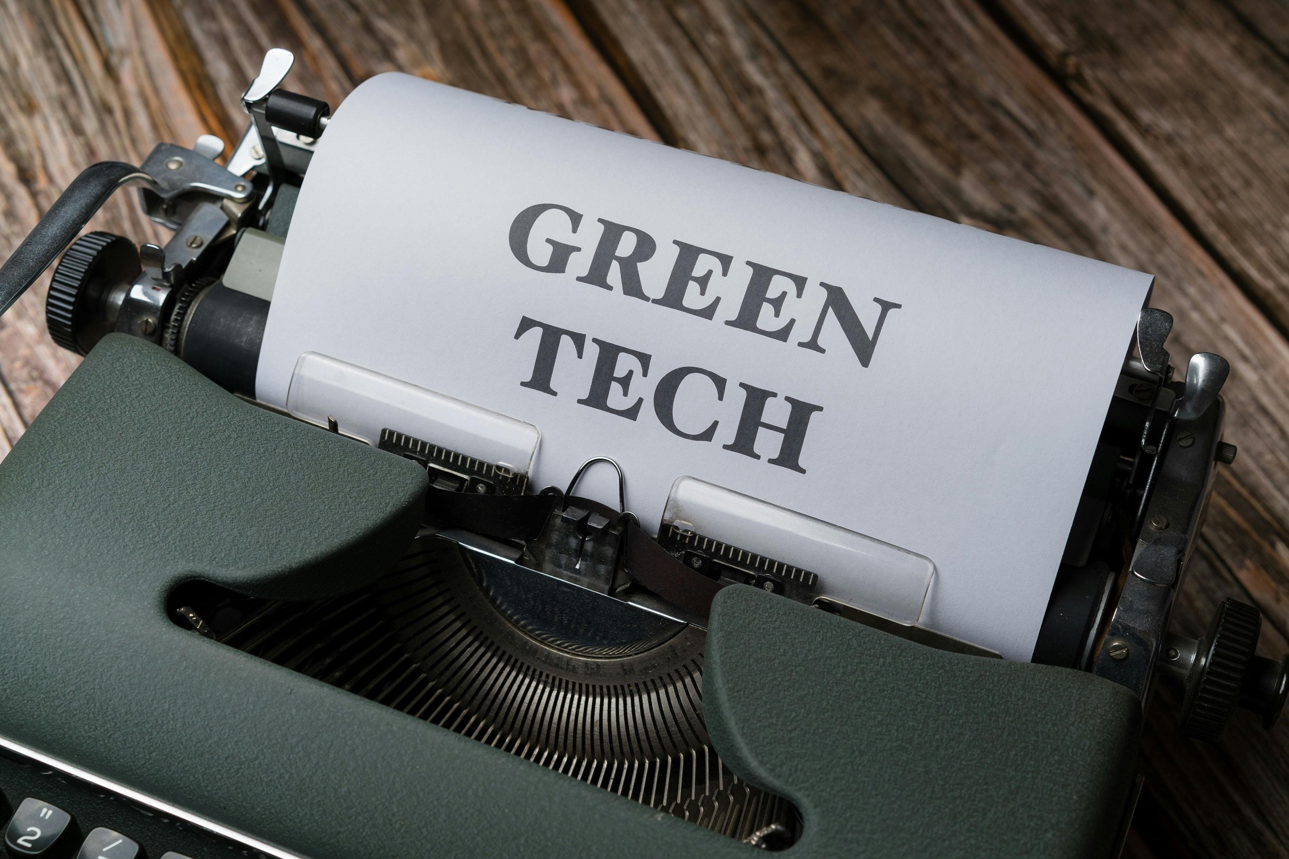 Typewriter that has a piece of paper coming out that says GREEN TECH